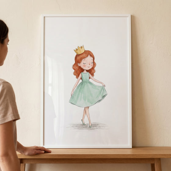 Framed red hair crown girl wall art shows a girl in a green dress, displayed on a wooden table against a neutral wall.