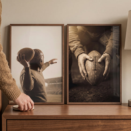 Rustic brown grainy football sports wall art set of 2 depicting vintage scenes in wood frames on a dresser.
