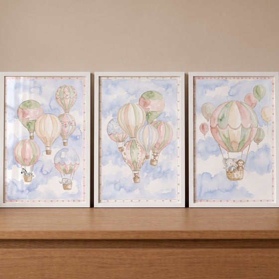 Sage blush animal balloon wall art set of 3 features cute animals in hot air balloons over soft watercolor clouds.