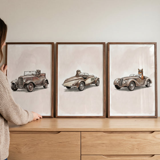 Sepia speedster woodland animal wall art set of 3 featuring a raccoon, bear, and fox driving vintage cars in wood frames.