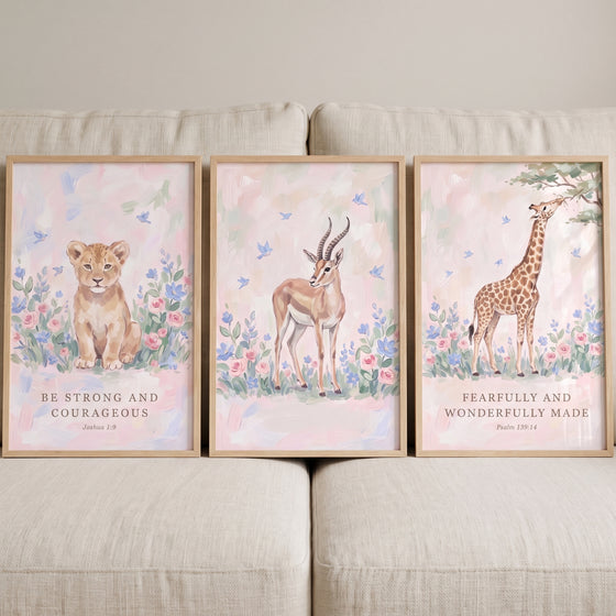 Serene botanical savanna animals artwork set of 3 featuring a lion, gazelle, and giraffe with Bible verses on a beige sofa.