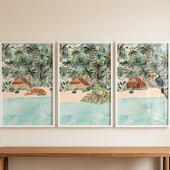 Serene island watercolor animals wall art set of 3 featuring a tiger, frog, and toucan near tropical beach huts.