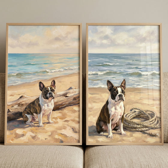 serene seaside boston terrier wall art set of 2 shows two dogs on a beach sitting by driftwood and a coiled rope.