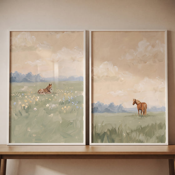 Serene summer field horse wall art set of 2 featuring horses in soft meadows, displayed on a wooden table.