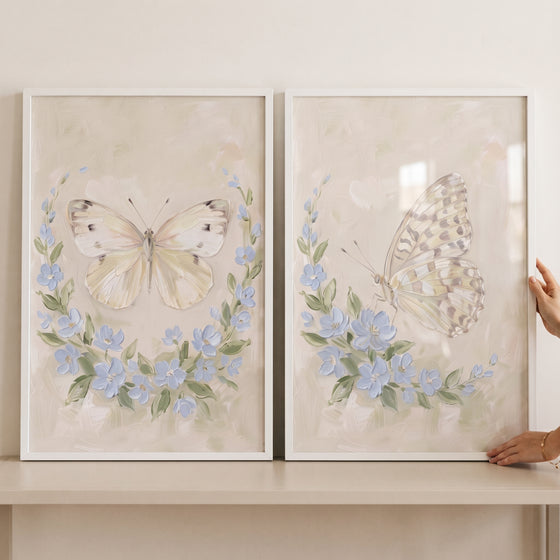 Shabby chic cottage butterfly wall art set of 2 with butterflies and blue flowers in white frames.