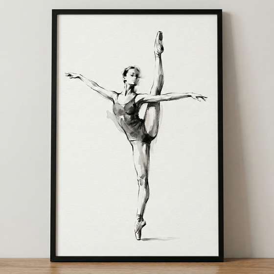 A black and white sketch of a ballet dancer in a graceful, athletic pose. She stands on one leg en pointe with her other leg extended vertically in a high split. Her arms are outstretched to the sides, and she wears a simple leotard. The illustration uses expressive lines and soft ink-like washes on a white background. The artwork is displayed in a minimalist black frame, leaning against a neutral-colored wall on a wooden surface.