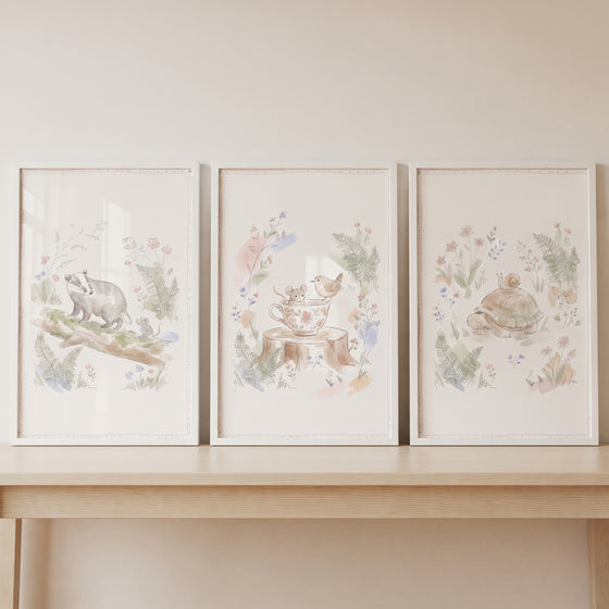 Sketched wildflower woodland animal wall art set of 3 shows a badger, a mouse in a teacup, and a turtle on a shelf.