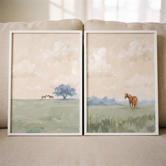 Soft apricot sky horses wall art set of 2 showing horses in a green field with a blue tree and a hazy sky.