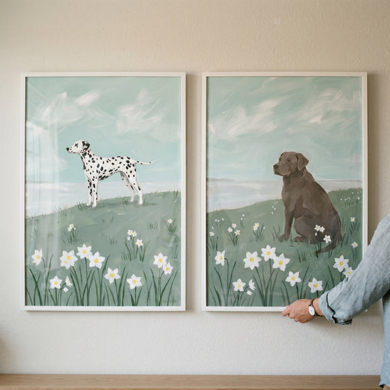 Soft coastal narcissus dogs wall art set of 2 depicting a Dalmatian and brown dog in a field of white flowers.