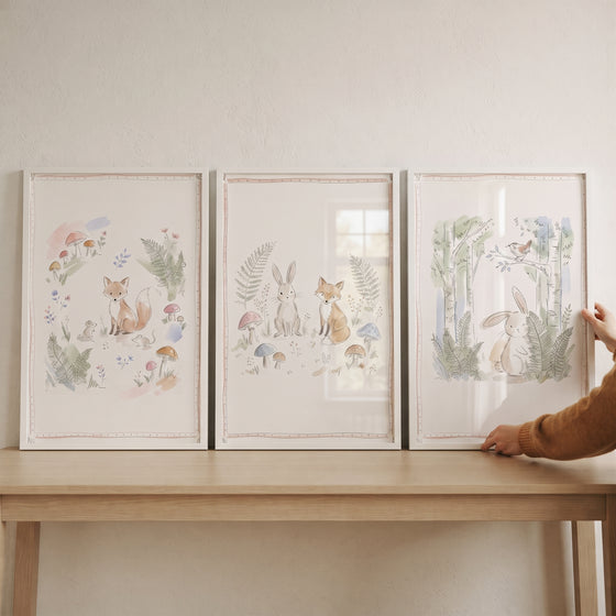 Soft foliage forest animals wall art set of 3 featuring foxes and rabbits displayed on a wooden table.