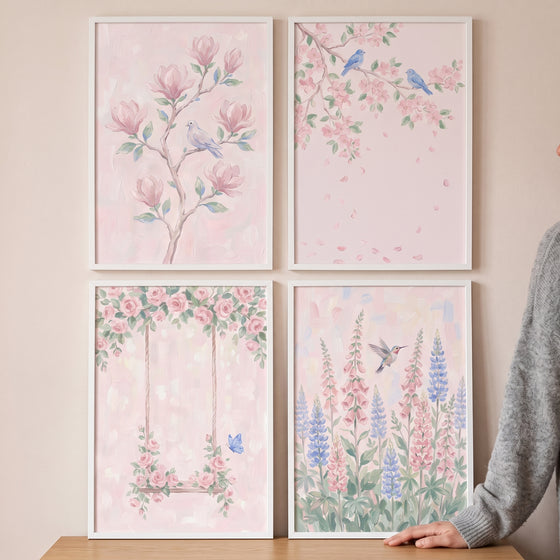 Soft pastel pink garden wall art set of 4 showing birds, magnolias, cherry blossoms, a floral swing, and lupine flowers.