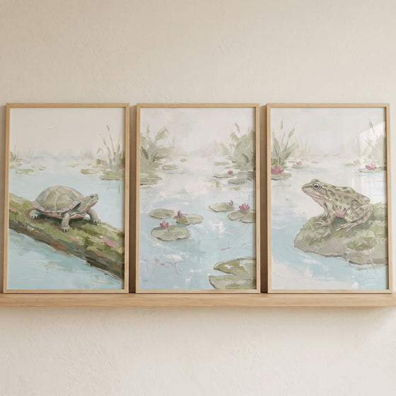 Soft pastel sage pond print set of 3 featuring a turtle, lily pads, and a frog in wood frames on a shelf.