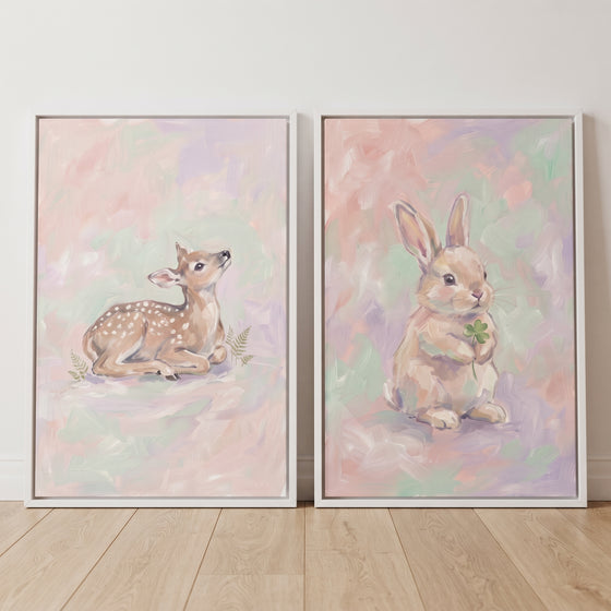 Soft whimsical woodland animal wall art set of 2 featuring a spotted fawn and a rabbit with a clover on pastel backgrounds.