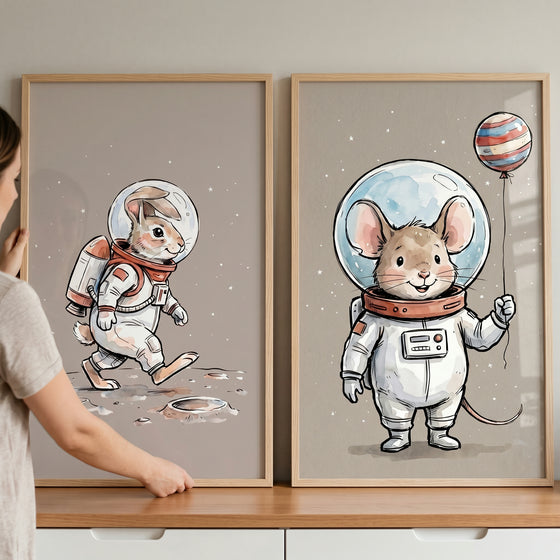 Framed space explorer animal wall art set of 2 with a rabbit on the moon and a mouse holding a planet balloon.