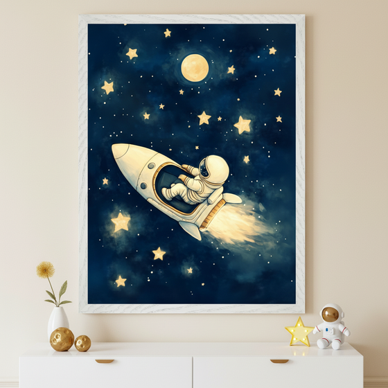 Framed illustration of an astronaut riding a rocket ship through a star-filled night sky, with a glowing moon and yellow stars scattered around. Below the artwork, a white cabinet displays a vase with a flower, two gold decorative balls, and a toy astronaut holding a yellow star.