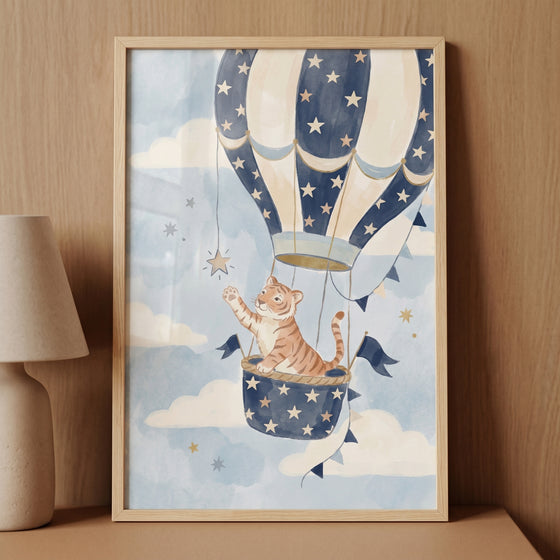 Star reaching watercolor tiger wall art with a tiger cub in a blue hot air balloon basket reaching for a star.