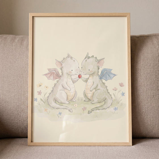Strawberry sharing baby dragons wall art shows two watercolor creatures holding a strawberry in a field of flowers.