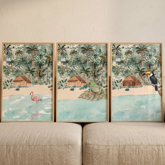 Tropical jungle beach hut animals wall art set of 3 with a pink flamingo, green frog, and toucan by the water.