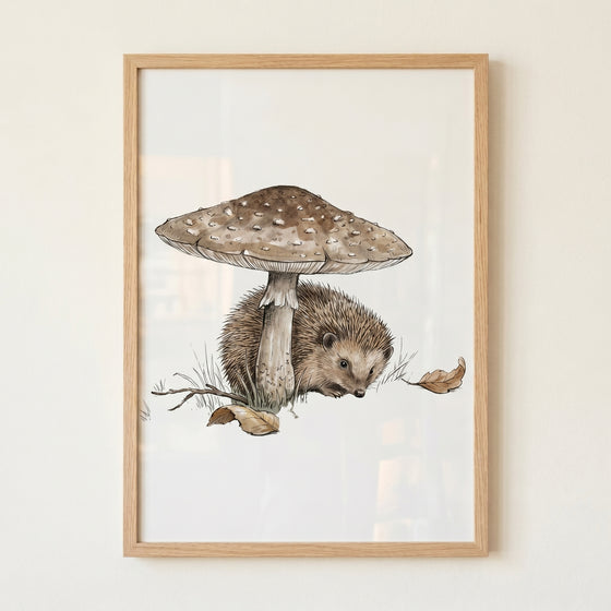 Under mushroom woodland hedgehog wall art of a brown hedgehog nestled beneath a large mushroom in a light wood frame.