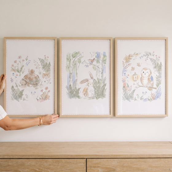 Vintage botanical woodland animals wall art set of 3 featuring a turtle, rabbit, and owl in light wood frames.