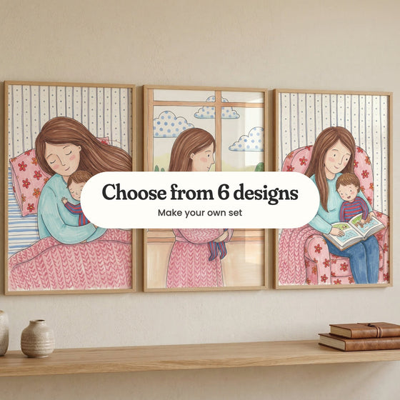 Three mother and child prints in light wood frames on a beige wall above a wood shelf with vases and books: a mother cuddling her sleeping baby in bed, a mother holding her baby by a window and a mother reading a picture book with her little boy in a flowery armchair, with a label reading Choose from 6 designs, Make your own set