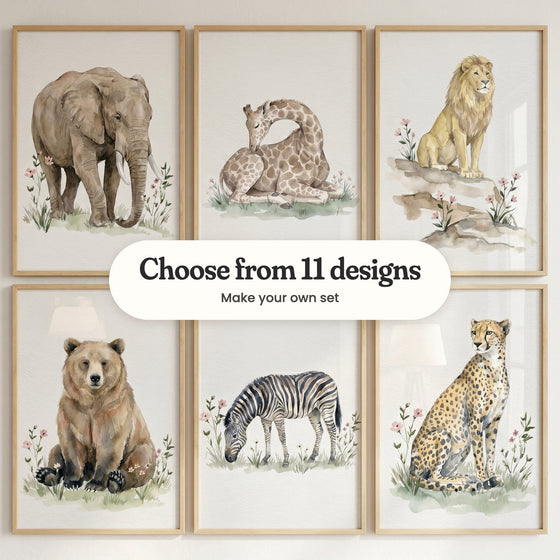 Six watercolor-style animal prints in light wood frames: an elephant in pink wildflowers, a sleeping giraffe, a lion on the rocks, a bear, a grazing zebra and a cheetah, with a label reading Choose from 11 designs, Make your own set