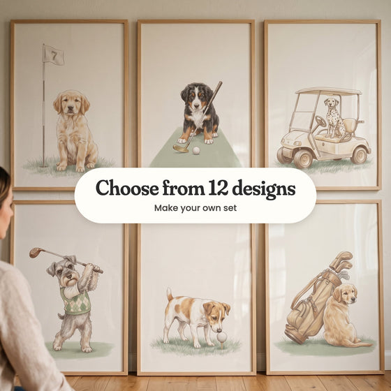 Six golfing dog prints in light wood frames leaning against a wall on a wood floor, beside a seated woman: a puppy by a flag numbered 7, a Bernese puppy with a putter, a Dalmatian in a golf cart, a schnauzer mid-swing, a Jack Russell sniffing a ball on a tee and a golden puppy leaning on a golf bag, with a label reading Choose from 12 designs, Make your own set