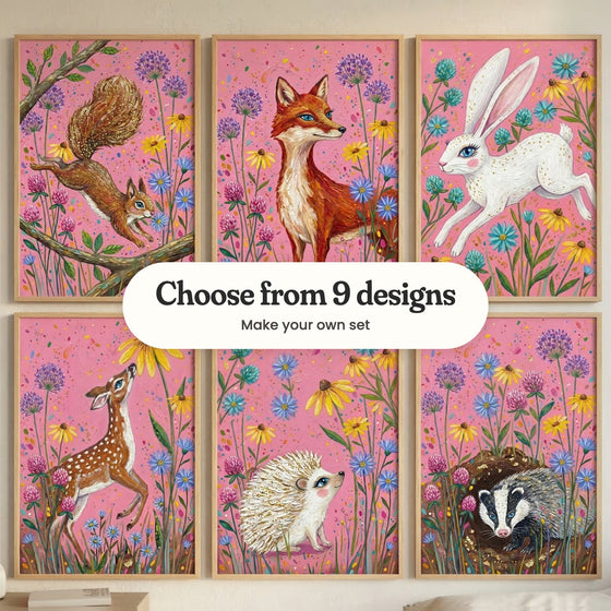 Six forest animal prints in light wood frames in two rows on a cream wall: a squirrel leaping between branches, a red fox among wildflowers, a white rabbit leaping among flowers, a spotted fawn sniffing a coneflower, a white hedgehog with gold-tipped spines and a badger peeking out of its burrow, with a label reading Choose from 9 designs, Make your own set