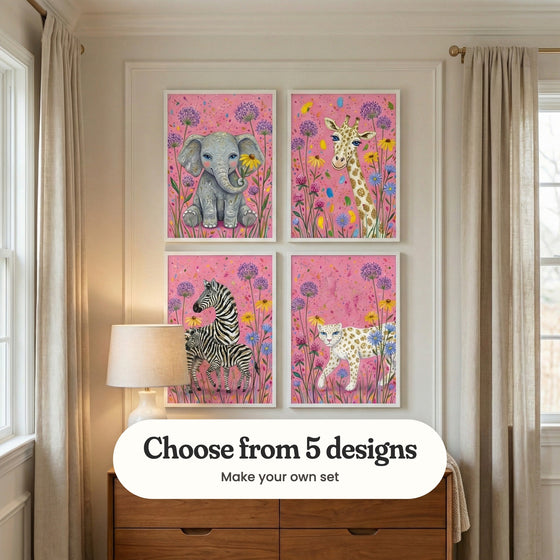 Cream panelled nursery with four safari animal prints in white frames in two rows above a walnut dresser with a glowing table lamp, between linen curtains: Sparkling Floral Friend, Glitter Spot Giraffe, Golden Stripe Duo and Golden Meadow Leopard, with a label reading Choose from 5 designs, Make your own set