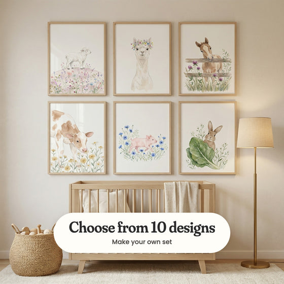 Nursery with six baby farm animal prints in light wood frames in two rows above a light wood crib with a knit throw, beside a woven basket of wooden toys and a brass floor lamp: Sweet Meadow Lamb, Floral Alpaca Portrait, Curious Meadow Foal, Daisy Meadow Calf, Piglet In Flowers and Curious Garden Bunny, with a label reading Choose from 10 designs, Make your own set
