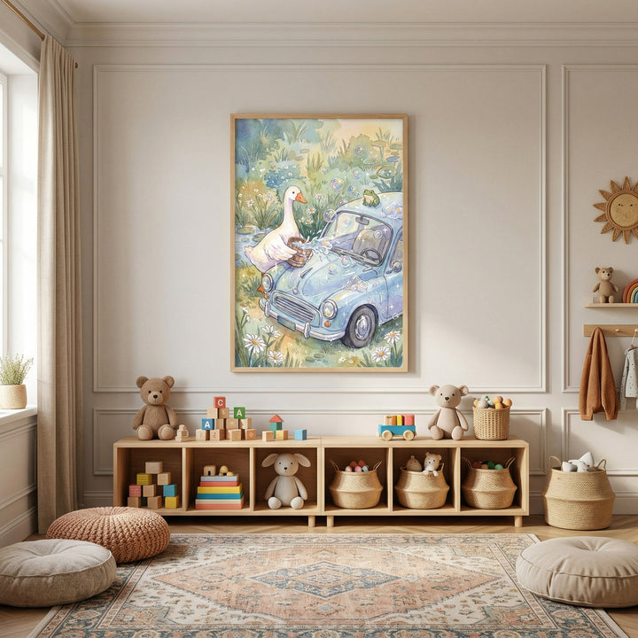A warm and inviting children's playroom features neutral-toned walls and light wood furniture. Centered on the main wall is a large, framed vertical illustration depicting a whimsical scene: a white goose with an orange beak is busy washing a small, blue vintage-style car in a lush field of daisies and greenery. A tiny green frog sits perched on top of the car's roof.