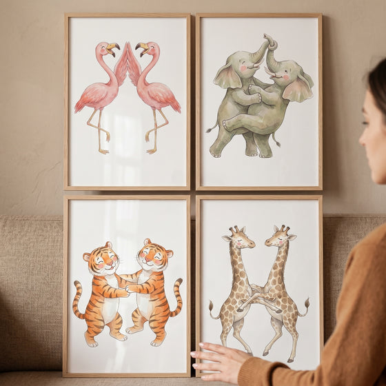 Watercolor hugging wild animal wall art set of 4 featuring framed prints of flamingos, elephants, tigers, and giraffes.
