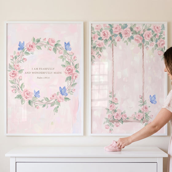 Watercolor pink butterfly rose wall art set of 2 featuring a floral wreath with a Bible verse and a rose-covered swing.