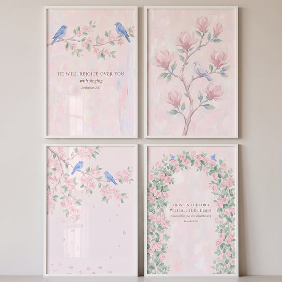 Whimsical botanical blue bird wall art set of 4 with pink floral illustrations and biblical text in white frames.