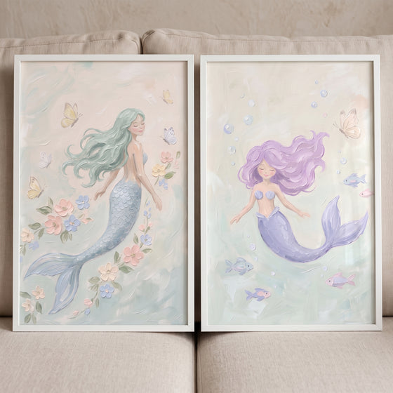 Whimsical pastel ocean mermaid wall art set of 2 featuring mermaids with flowers, butterflies, and fish in white frames.