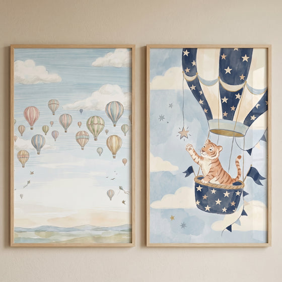 Whimsical pastel sky balloon wall art set of 2 shows a cartoon tiger reaching for a star and many floating balloons.
