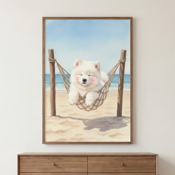 A vertical wooden frame hangs on a plain white wall, showcasing a watercolor-style illustration of a fluffy white puppy. The small dog, which has its eyes closed and rosy pink cheeks, rests comfortably inside a rope hammock. The hammock is suspended between two wooden posts anchored in the soft sand of a beach. In the background, a serene turquoise ocean meets a clear blue sky. Below the framed artwork sits a mid-toned wooden dresser with two drawers.