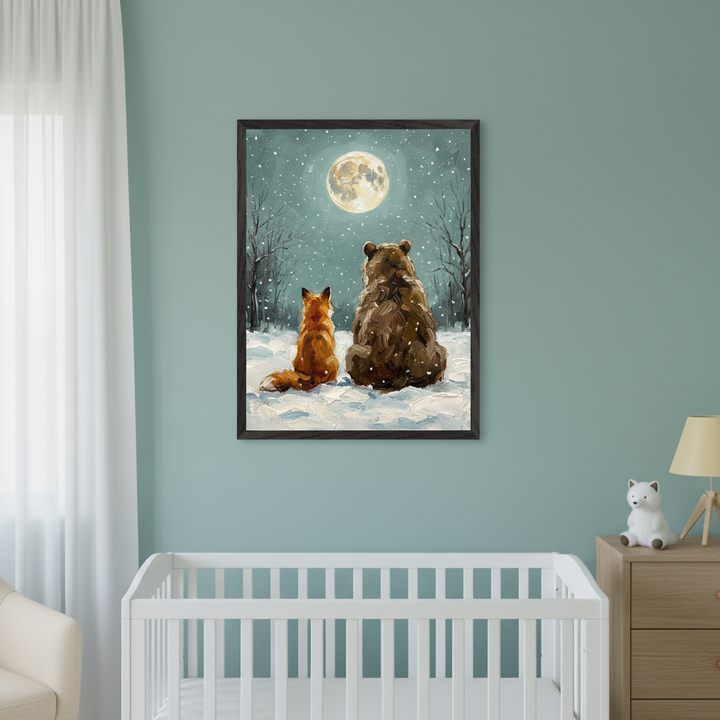 Modern nursery with a white crib, beige armchair, and wooden dresser against a light teal wall. A framed painting of a brown bear and an orange fox watching a full moon in a snowy forest hangs above the crib in a painterly style.