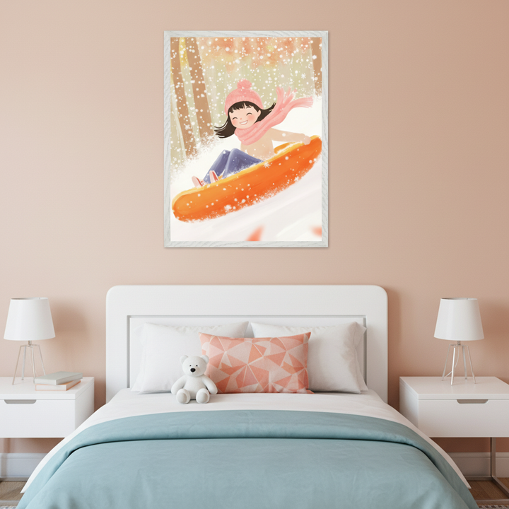 Modern nursery with a white crib against a blue wall. A white-framed cartoon illustration of a girl in a pink hat and scarf sledding on an orange sled in the snow hangs centered above the crib. A light armchair with a rust blanket and a wooden nightstand are also visible.