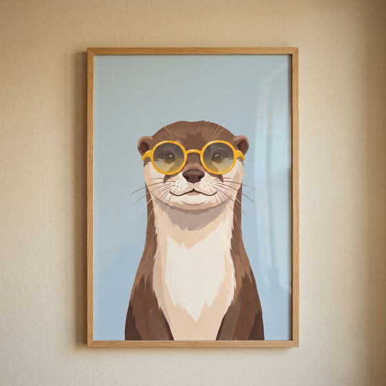 Framed yellow round glasses otter wall art featuring a cute brown otter against a light blue background.