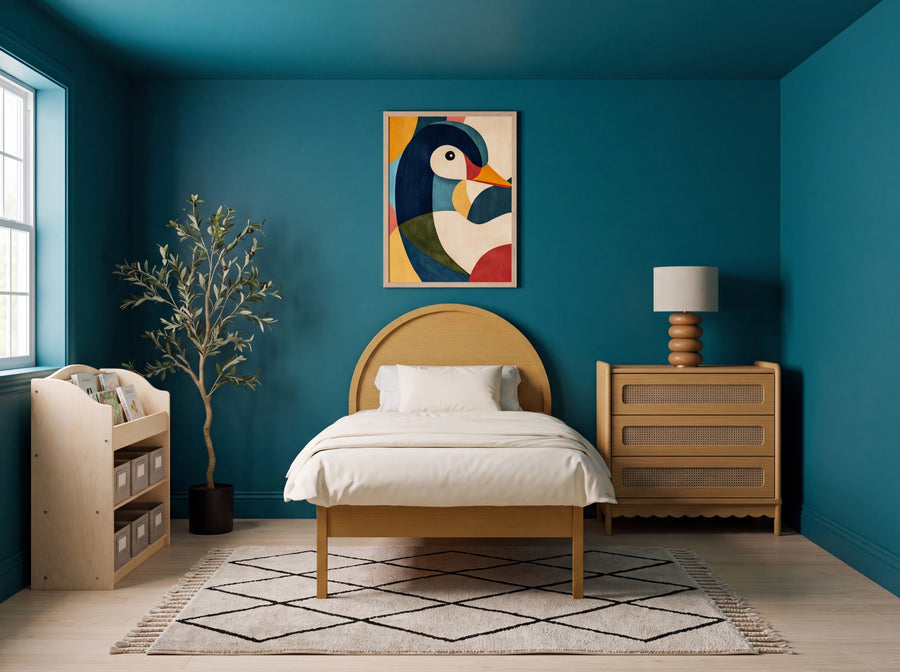A bold kids' room: a deep saturated teal accent wall and ceiling, a honey-oak arched twin bed with a cream duvet, and a colorful geometric duck art print above the bed