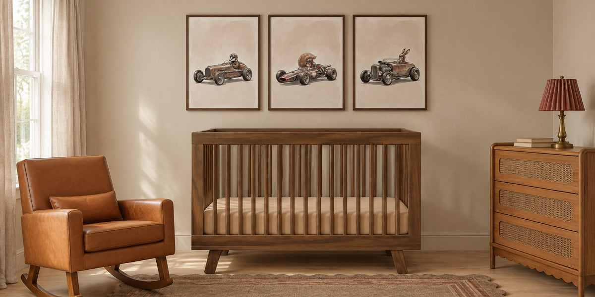 Car nursery: three vintage racing car prints of a badger, a squirrel and a rabbit above a walnut crib, with a cognac leather rocker and a cane dresser
