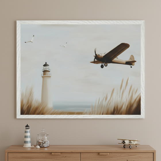 Neutral-toned room with a light wood dresser. A large framed painting hangs above the dresser, showing a lighthouse, biplane, and seagulls over coastal grass and the sea. On the dresser are a striped lighthouse, jar of shells, and a toy biplane.