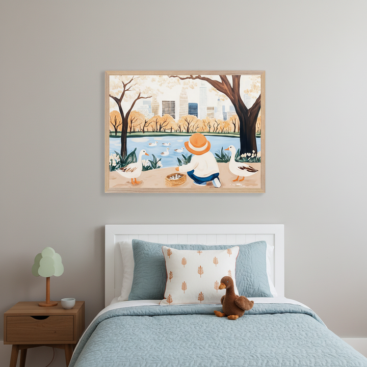 Kid's bedroom with a white headboard bed and wooden nightstand. A large framed illustration of a child in a hat feeding ducks by a pond with a city skyline and autumn trees hangs above the bed. The bed has light blue bedding and a brown duck plush toy.