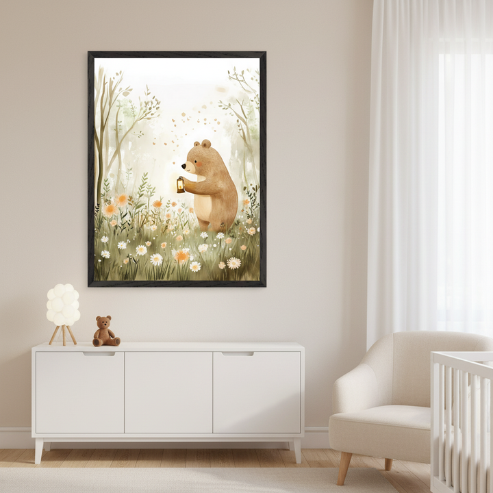 Modern nursery with light beige walls. A large framed print of a watercolor brown bear holding a lantern in a flowery forest hangs above a white three-door dresser. A beige armchair and a white crib are to the right. A small lamp and teddy bear are on the dresser.