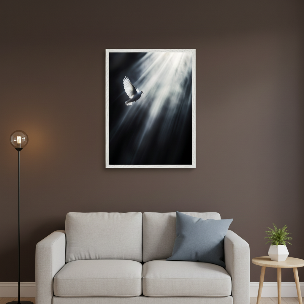 Modern living room with a light gray sofa against a brown wall. A framed black and white print of a white dove flying through light rays hangs centered above the sofa. A floor lamp stands to the left, and a small side table with a plant is to the right.