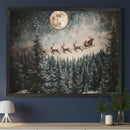 Modern living room featuring a light-colored console table. A large framed Christmas painting of Santa and reindeer flying over a snowy forest under a full moon hangs centered above the table. A white lamp, pine branches, and a candle adorn the console.