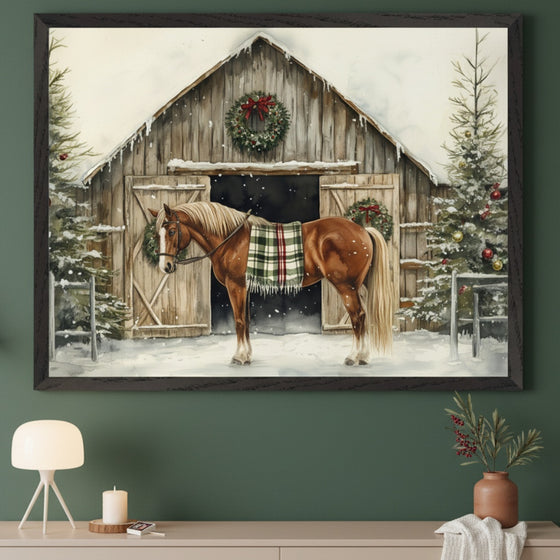 Modern room with a dark green wall. A large framed watercolor painting of a brown horse with a plaid blanket in front of a snow-covered barn and Christmas trees hangs above a light beige console table. A white lamp and a vase with branches are on the table.