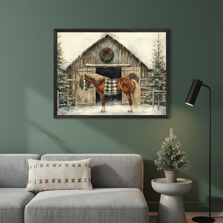 A large framed watercolor print of a brown horse with a plaid blanket in a snowy Christmas barn scene hangs centered above a light gray sectional sofa in a modern living room. A black side table with a lamp is to the sofa's right.