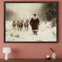 Contemporary living room with a dark wooden console table against a peach wall. A large framed print of Santa Claus leading five reindeer through a snowy, foggy landscape in a vintage painting style hangs above.